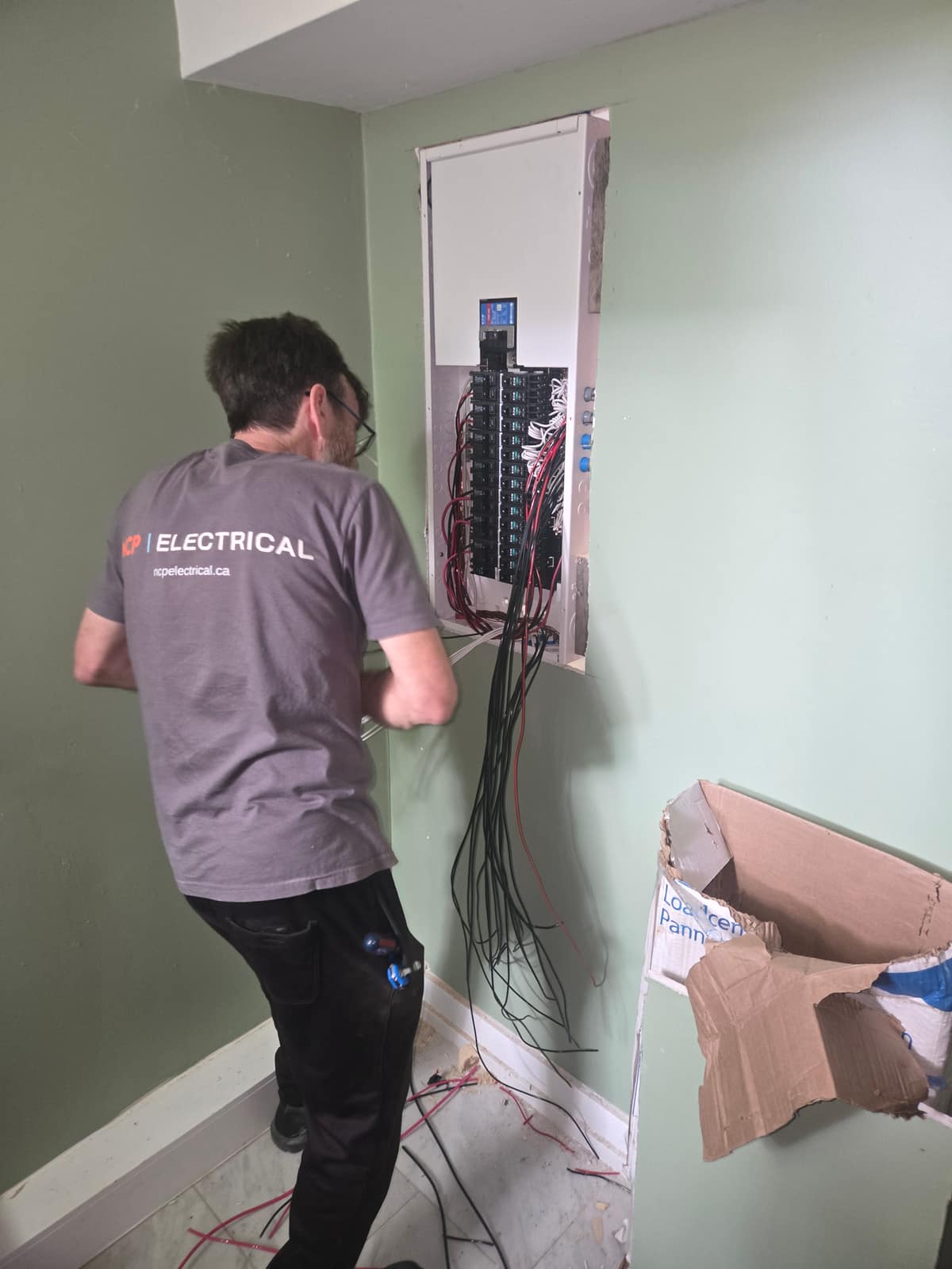 An NCP Electrical electrician replacing a residential electrical panel in a Greater Sudbury home